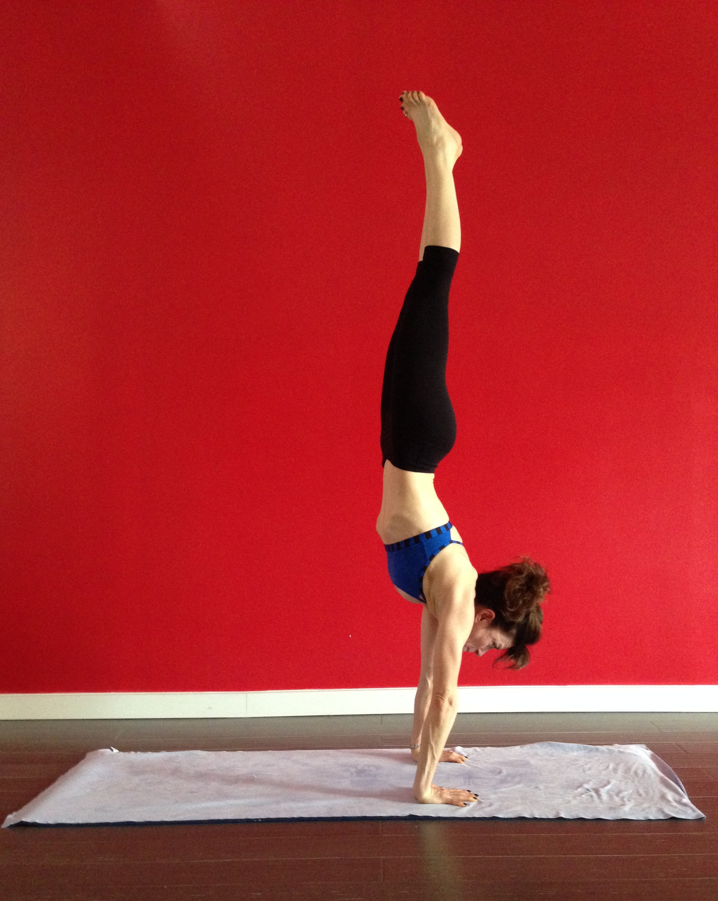 Anne Samit, handstand red wall picture.1