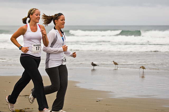 women jogging on beach exercise fun 