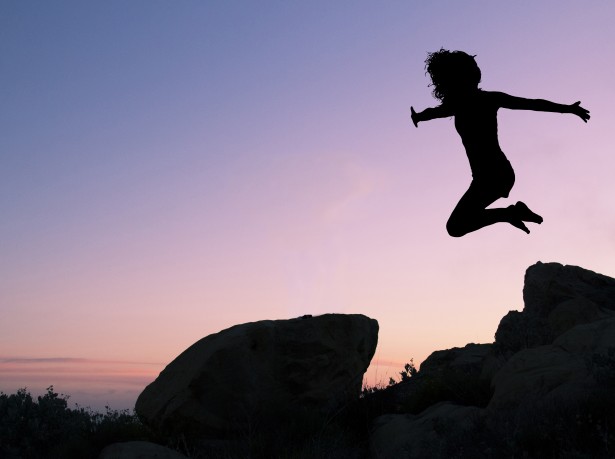 girl-leaping-off-rock
