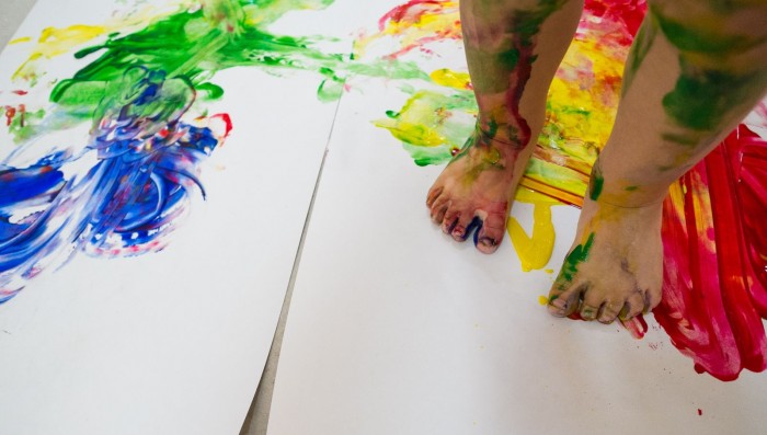 Toddler feet covered in paint.
