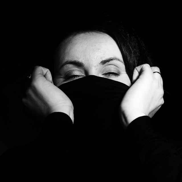 woman closed eyes mouth covered