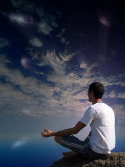 man meditate cliff sky clouds