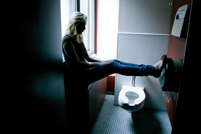sad grief depressed distraught woman bathroom blue