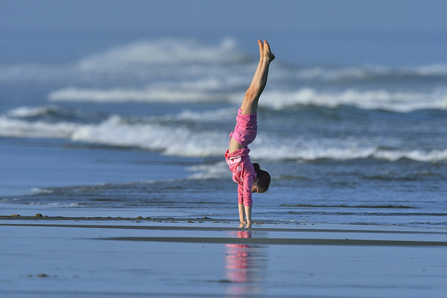 child beach yoga handstand