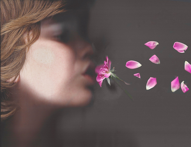blowing away letting go release girl flower petals