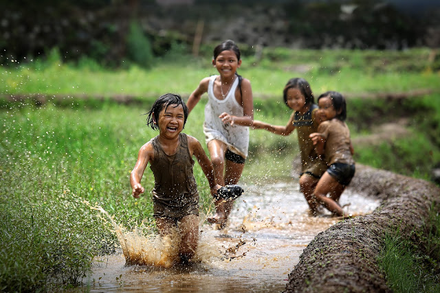 girls kids playing in mud laugh friends