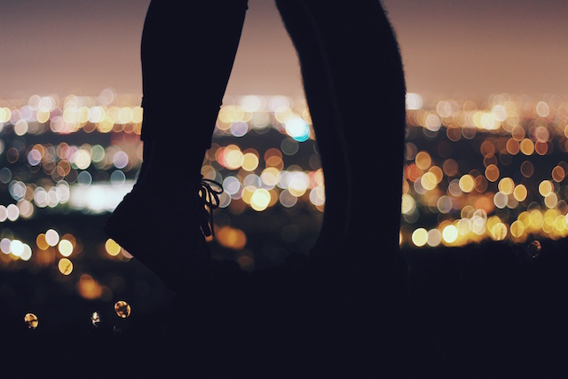 couple feet shoes city lights