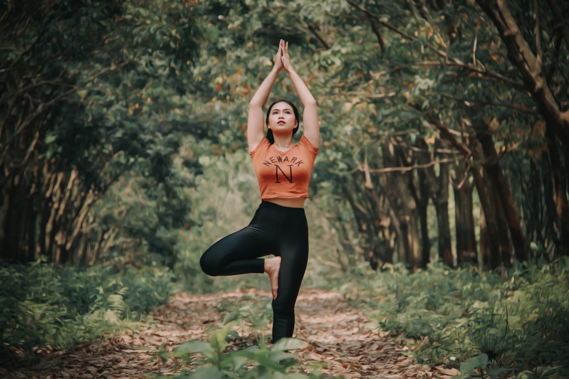 Girl prectising yoga in the forest