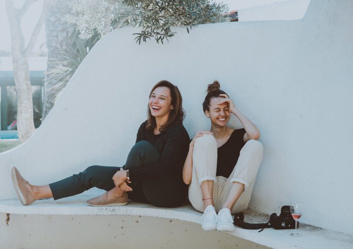 Elle Hughes/Pexels https://www.pexels.com/photo/two-women-sitting-on-white-bench-1549280/