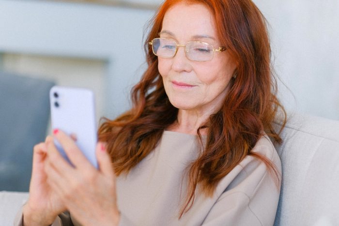 Anna Shvets/Pexels https://www.pexels.com/photo/elderly-woman-with-red-hair-in-eyeglasses-making-video-call-5257218/