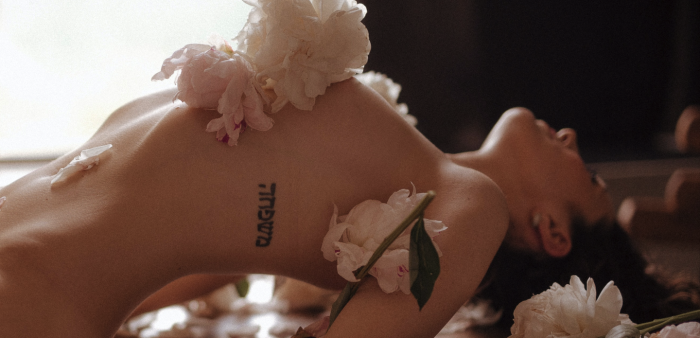 Marina Ryazantseva/Pexels https://www.pexels.com/photo/person-reclining-with-white-flowers-on-her-body-8672937/