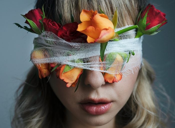 Monica Turlui/Pexels https://www.pexels.com/photo/unrecognizable-woman-with-blindfold-and-blooming-roses-7218408/