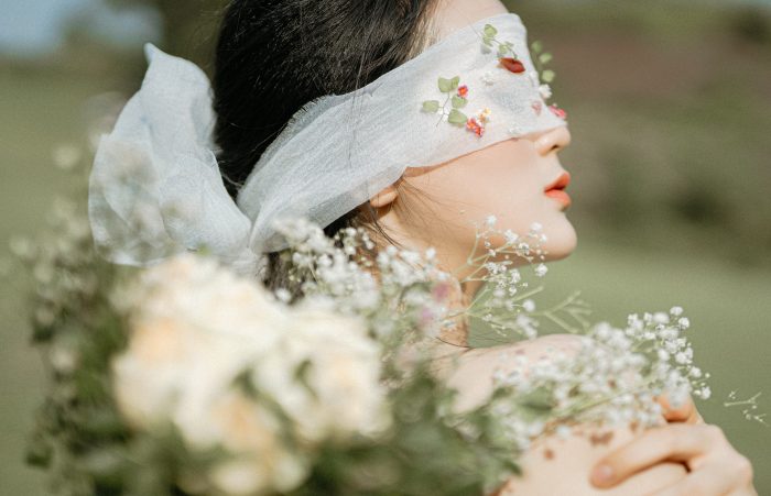 Trần Long/Pexels https://www.pexels.com/photo/faceless-ethnic-woman-covering-eyes-with-veil-in-nature-6213337/