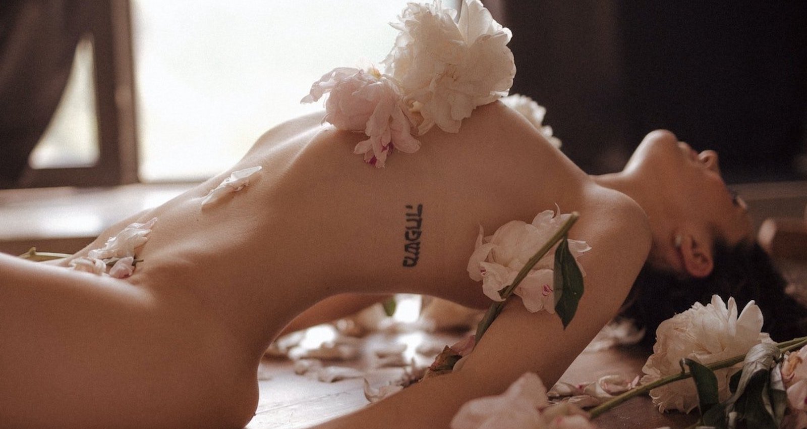 Marina Ryazantseva/Pexels https://www.pexels.com/photo/person-reclining-with-white-flowers-on-her-body-8672937/