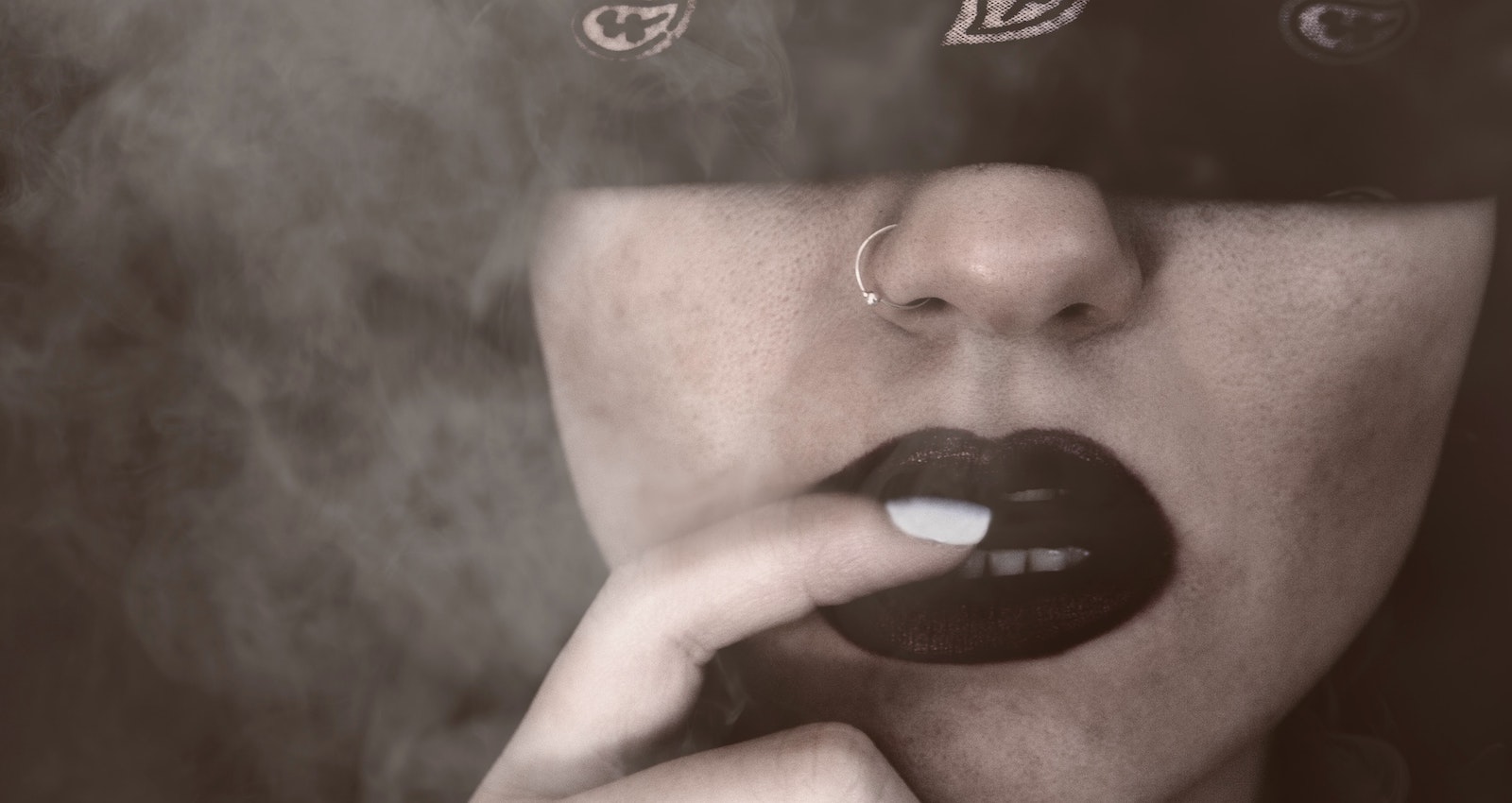 Tomas Andreopoulos/Pexels https://www.pexels.com/photo/blindfolded-woman-with-finger-on-lips-grayscale-portrait-731864/